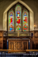 Stained glass windows in an ancient Welsh church, north Wales UK