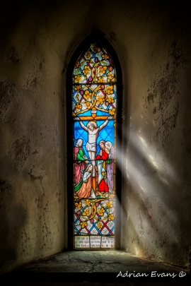 ancient stained glass window north Wales, UK Crucifixion of Jesus Christ. The acronym INRI (Latin: Iēsus Nazarēnus, Rēx Iūdaeōrum) represents the Latin inscription which in English reads as Jesus the Nazarene, King of the Jews.